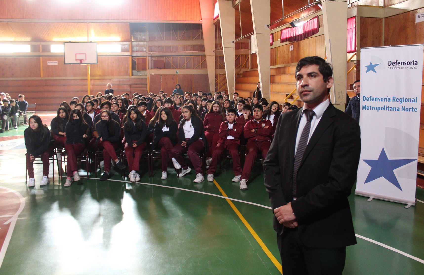 Junto a 300 alumnos del colegio "Mater Dolorosa", el defensor penal juvenil Joaquín Müller observa videos alusivos a la LRPA.
