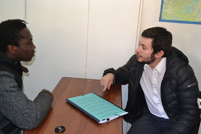 El defensor penal público Juan Pablo Alday y el perito traductor durante la conversación con el migrante haitiano que cumple prisión preventiva.